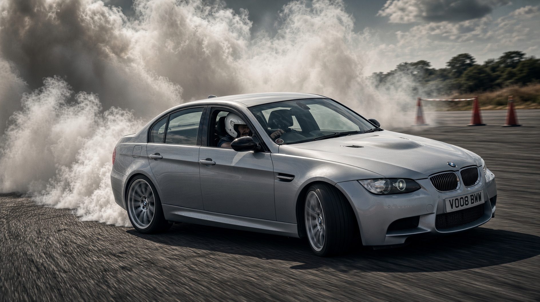 Chase Armitage drifting his silver BMW E90 M3 at Manston Raceway Park, smoke trailing from the rear tyres